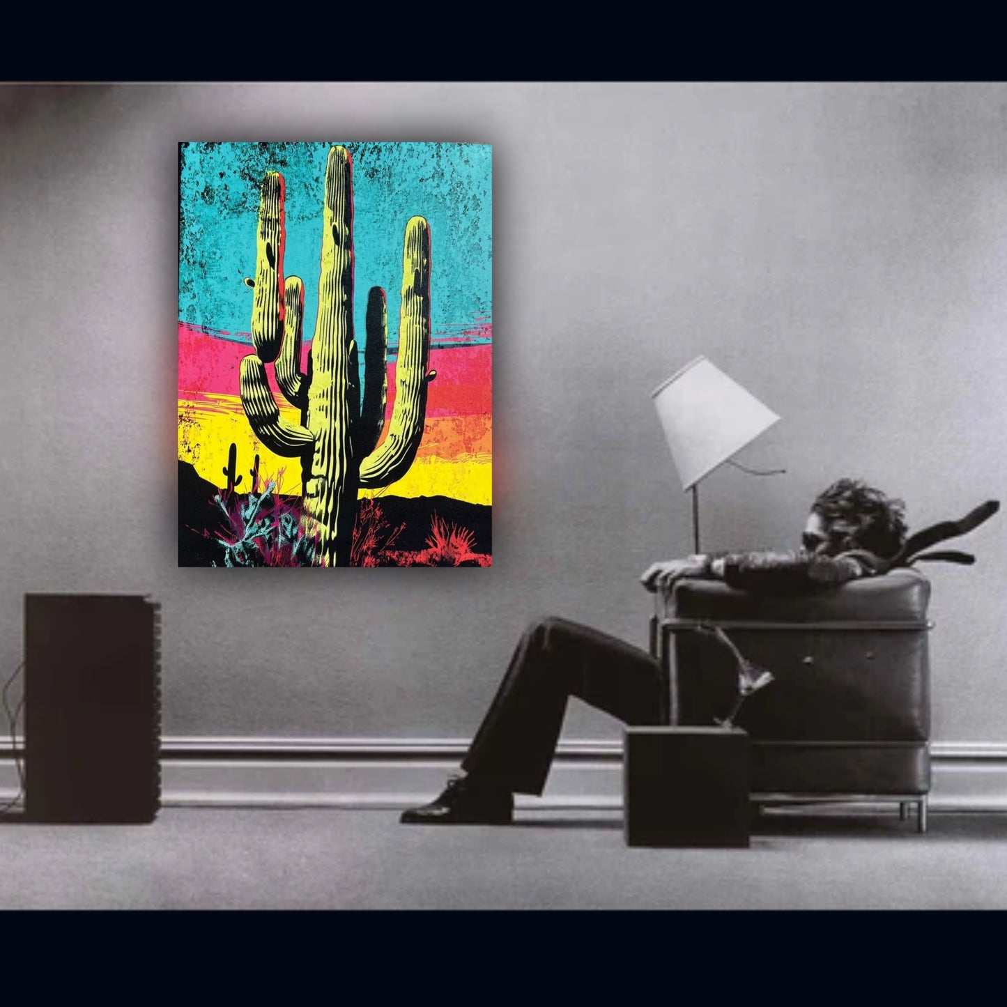 Colorful cactus painting on a wall with a person sitting in a chair below.